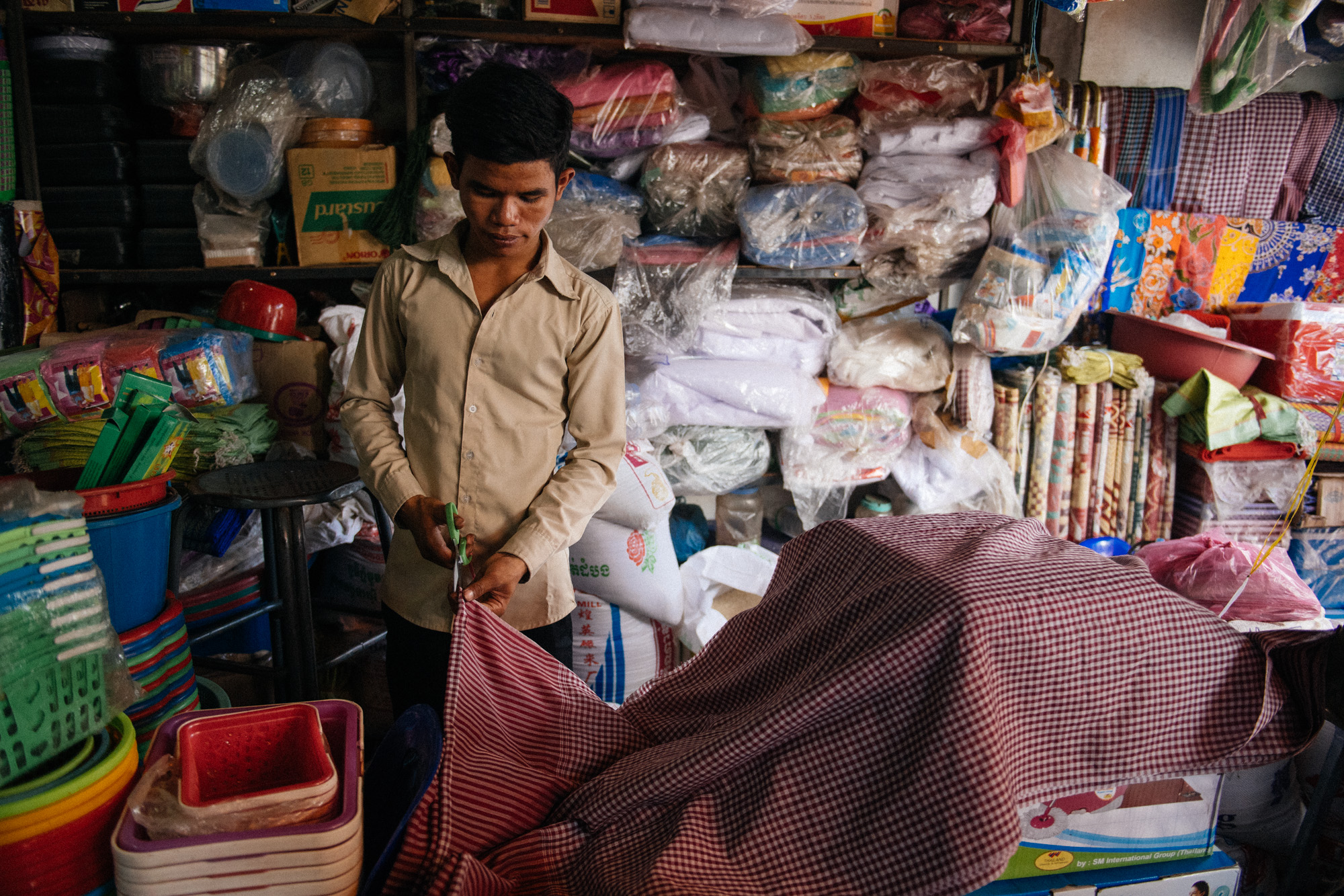 The Krama is a traditional Khmer garment. It is multi use scarf. Men wear it like a bandana, while women use it like a hood. It can also be work as a belt or just to wipe sweat of your face. You can go to the market and just pick your favorite pattern and size and the vendor will cut the fabric on the spot.