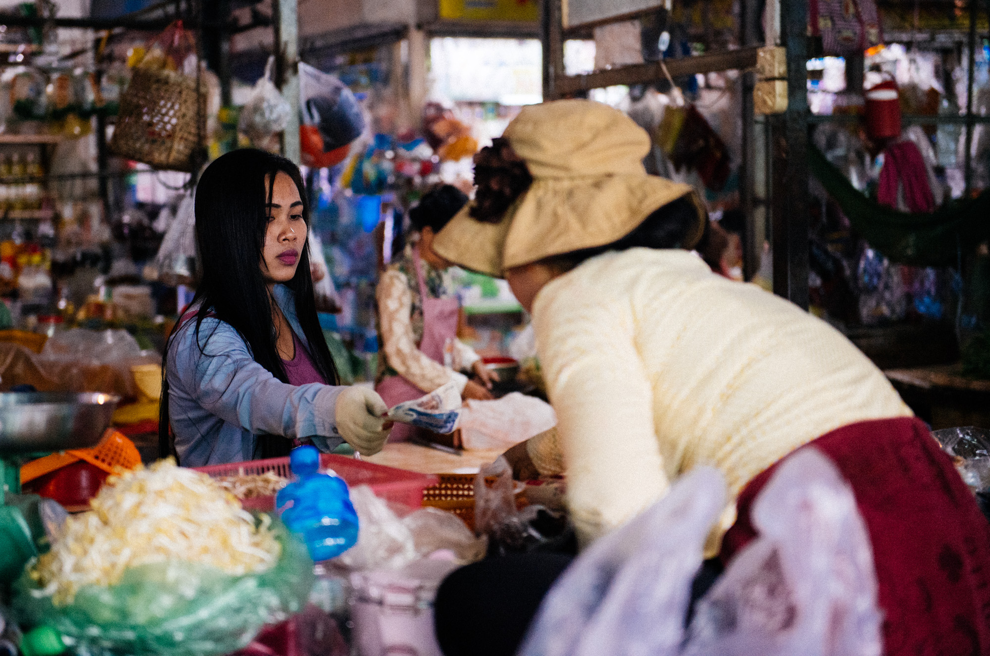 In Cambodia there are no coins. All money is paper. The smalles denomination is 100 Riel, equivalent to 0.02 US dollars. This woman is handing over 3000 riel for her groceries.