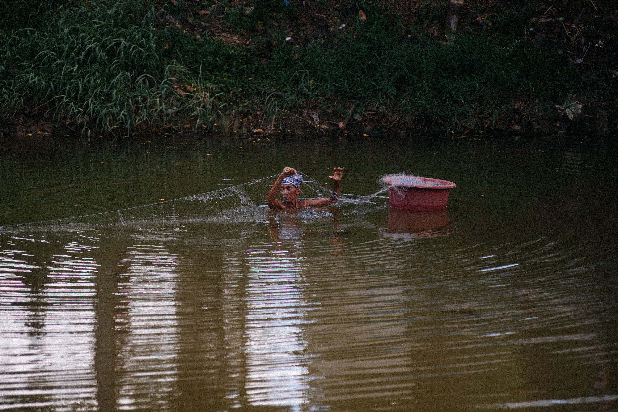 Man fishes in the river that cuts Siem Reap in half. This spot is exactly in front of the market from the previous post.