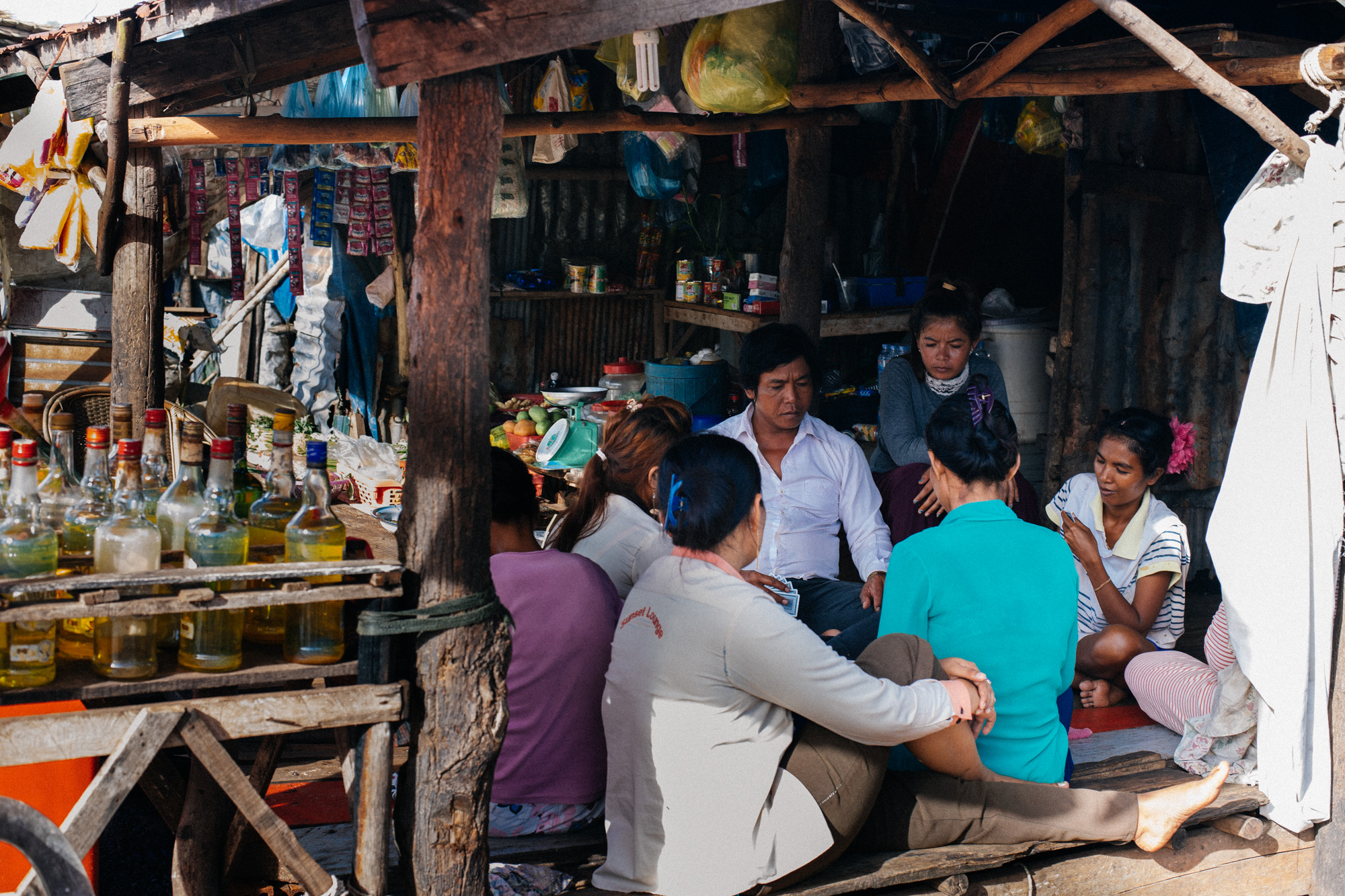 At the "gas station", a group of people plays cards to pass time.
