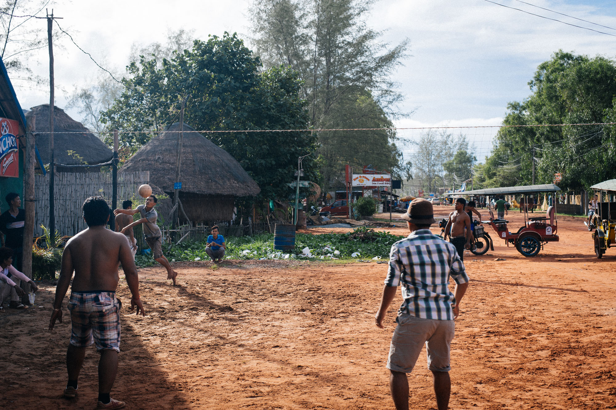 The locals like to play a version of volleyball, where you can't pass to your teammates and have to send the ball back over the net as soon as you get it. You also serve by using your feet.