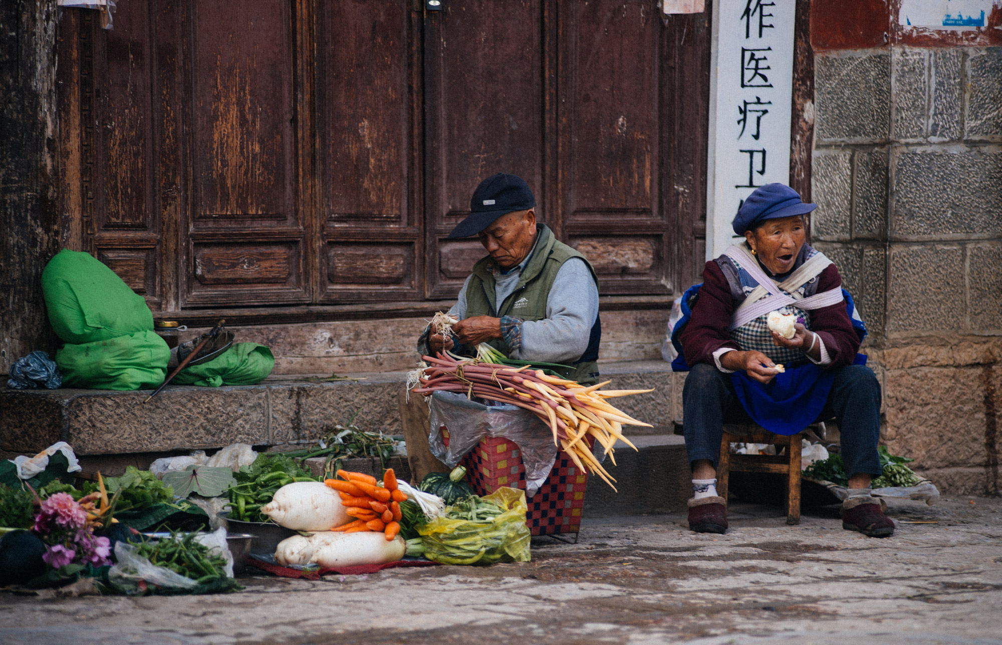  Early morning these two vendors get ready to sell their produce. 