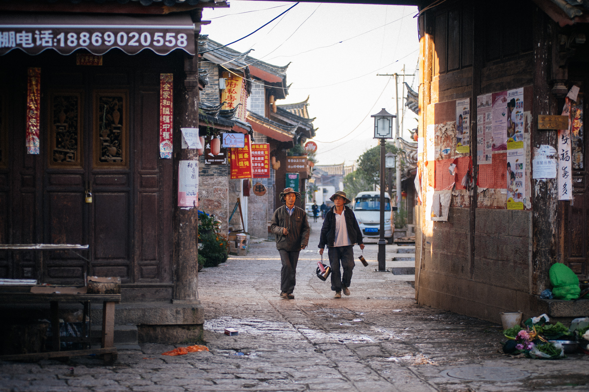  Men walk towards the city's main square early morning. In the back dozens of little restaurants that cater to tourists on high season. 