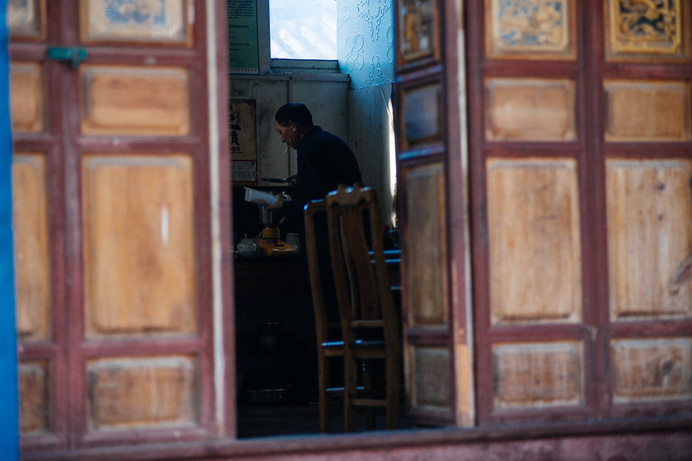  A man prepares food for a large group of monks. 