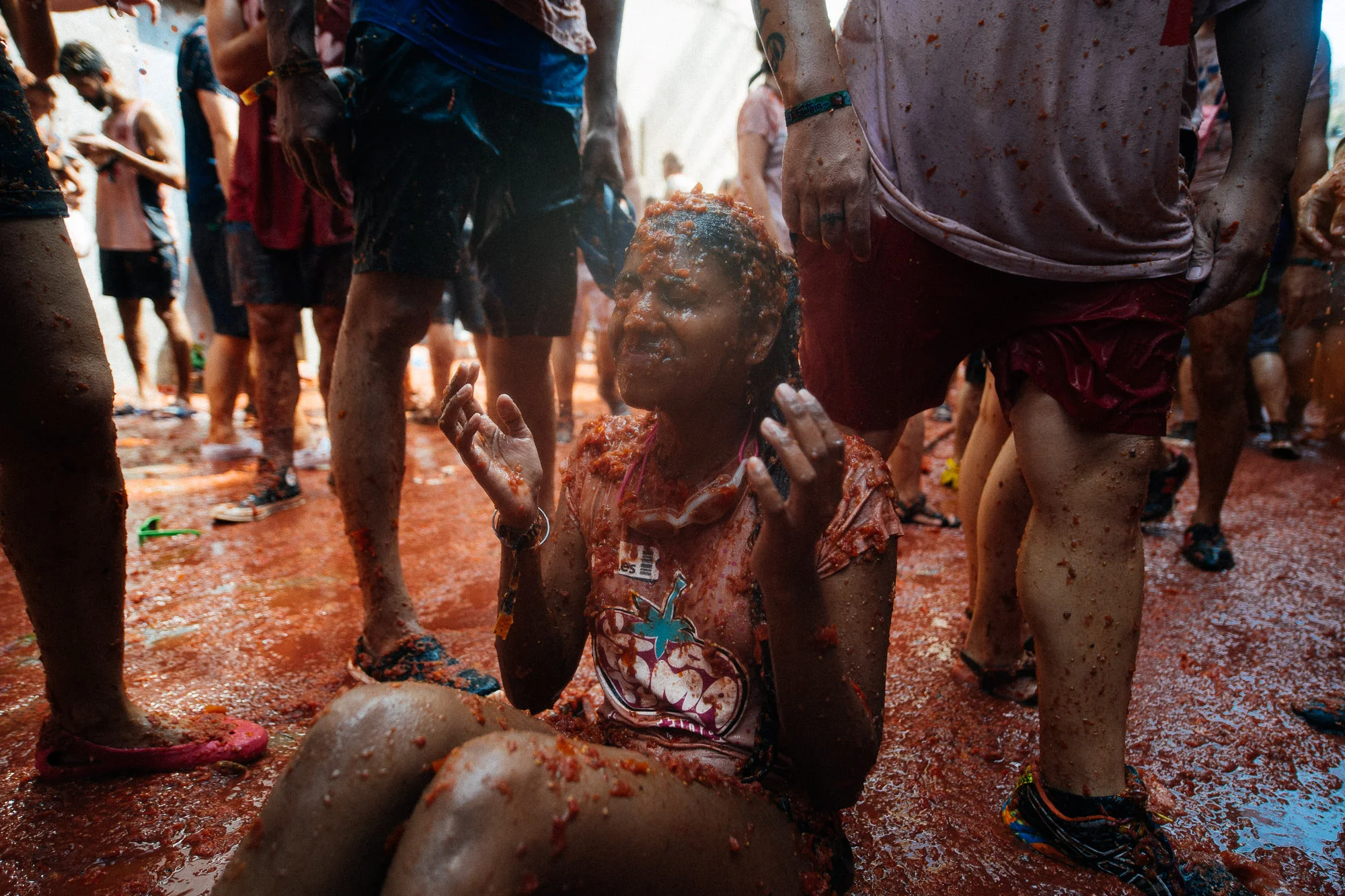 Tourist has tomatoes poured on her head for a photo.