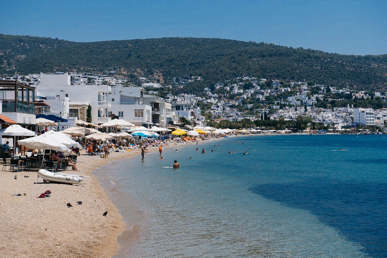 Hoards of tourists enjoy the sun in the crystal blue waters of the Mediterranean.