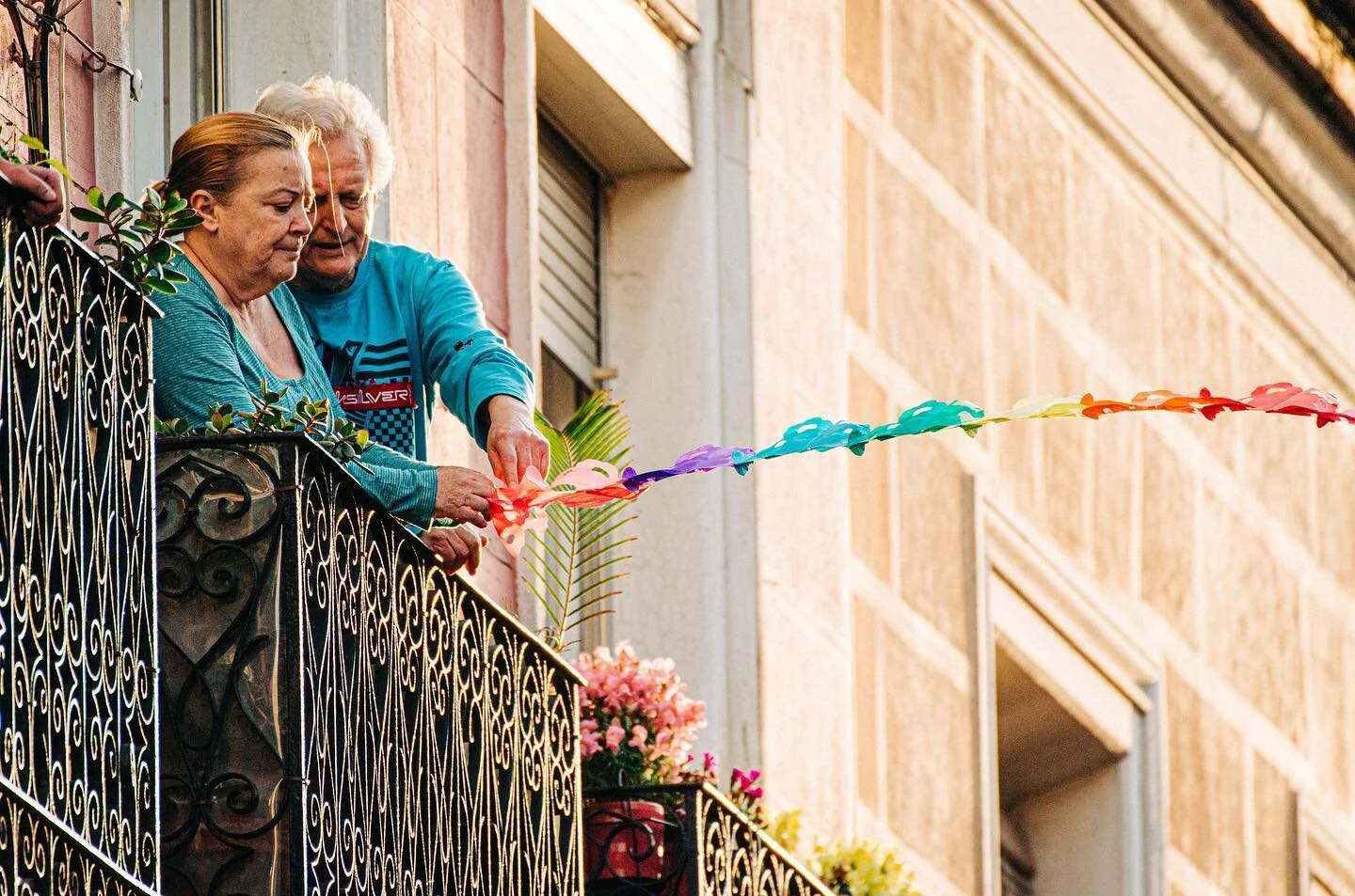 Neighbors hang decorations for May 2nd celebrations tomorrow. They threw the other end over to the neighbors in the opposite building. Not even the quarantine is stopping people from celebrating. Can’t wait to see what will happen tomorrow! #ma