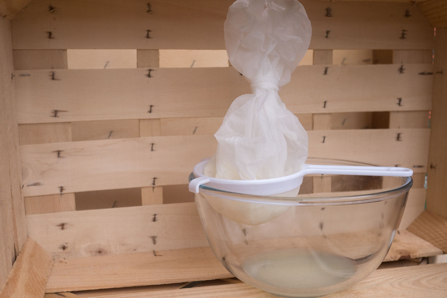4. Pour the ready-made milk kefir into a cheesecloth lined sieve hanging over a bowl. Tie it up and place it in the fridge overnight. You will be left with whey, the liquid at the bottom of the bowl.