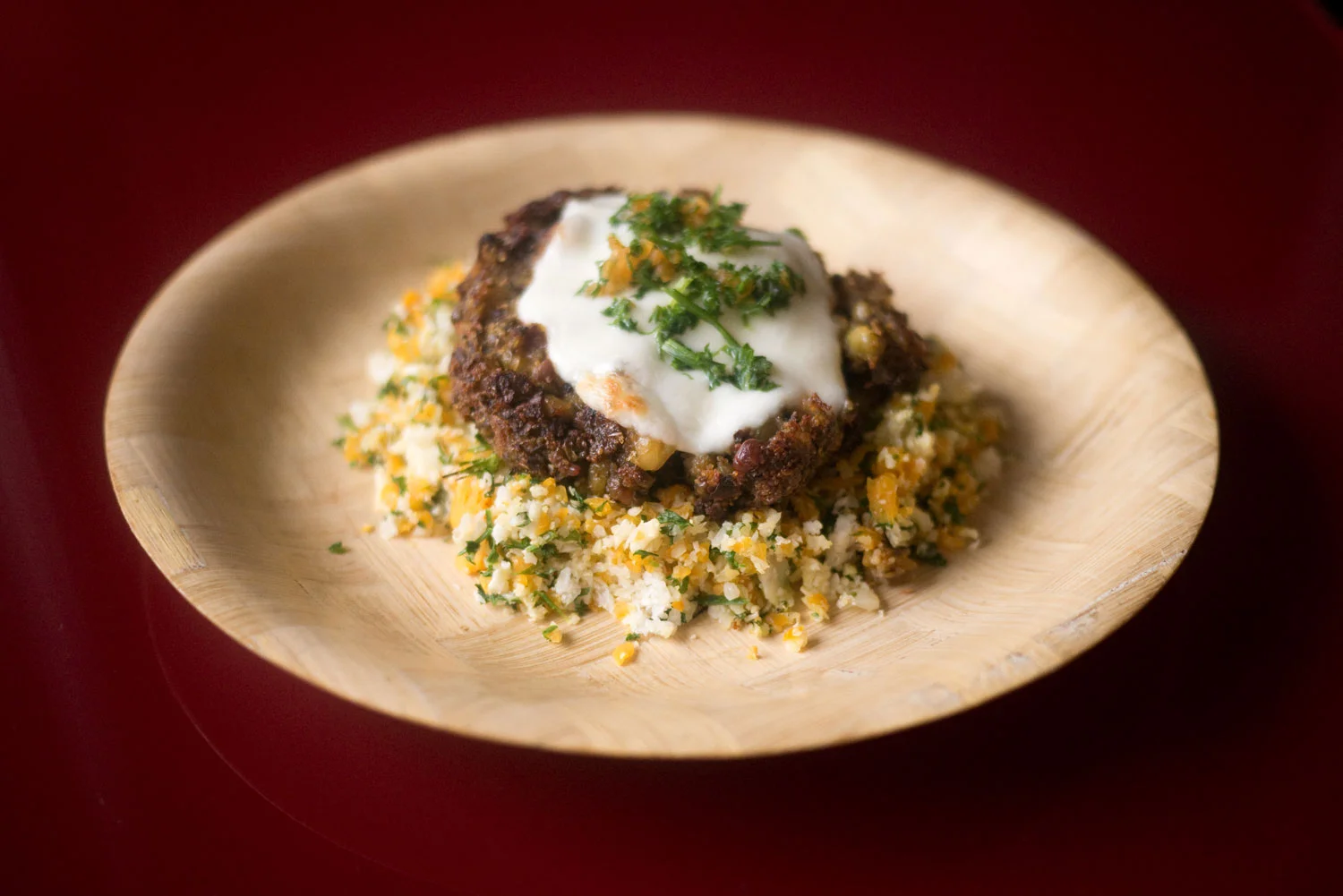 Teff patty on a bed of sautéed cauliflower & pumpkin topped off with parsley and mozzarella.
