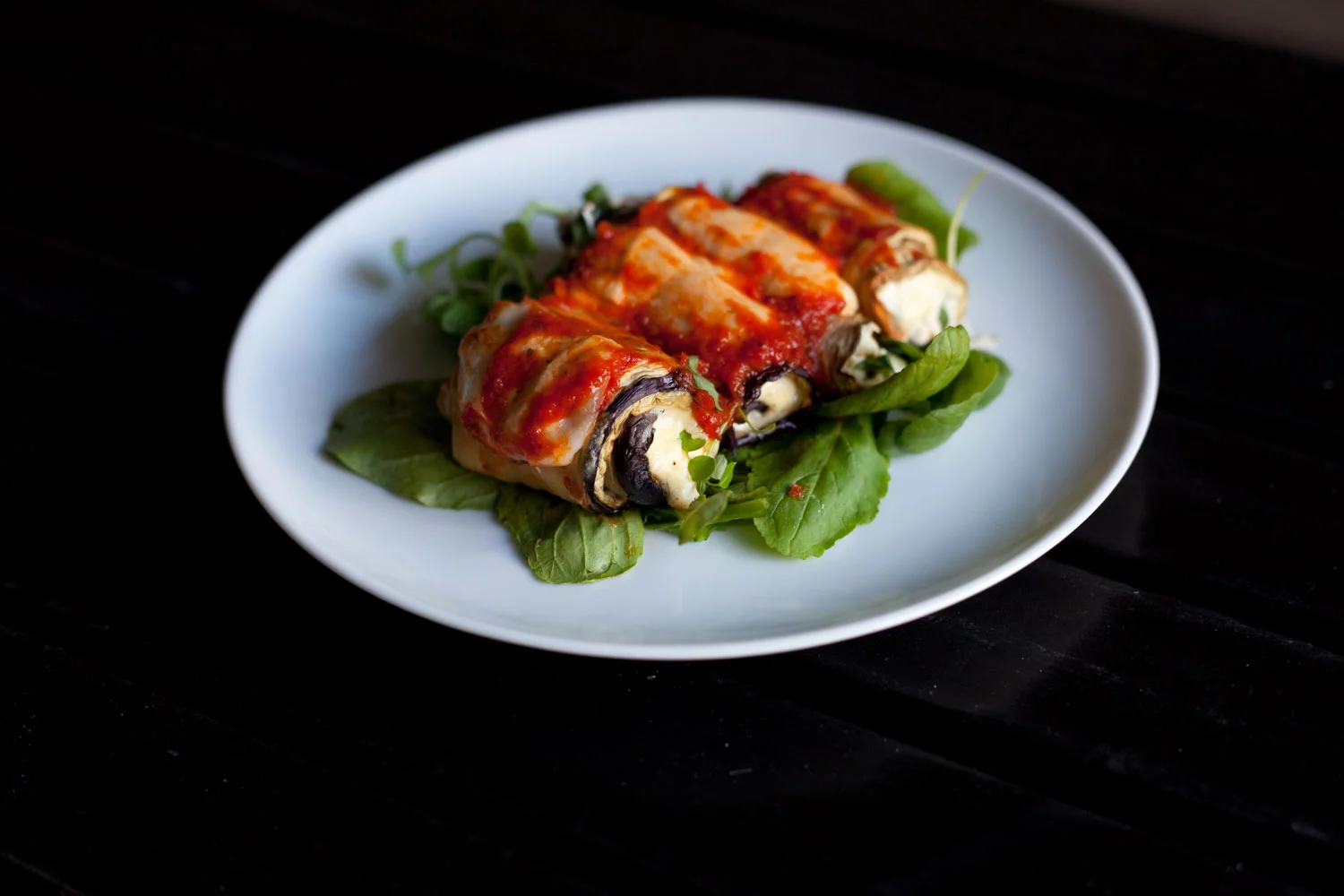 Eggplant Rolls on a bed of arugula.