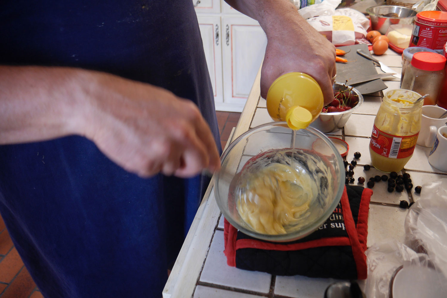 Drizzle a thin stream of oil while whisking continuously.