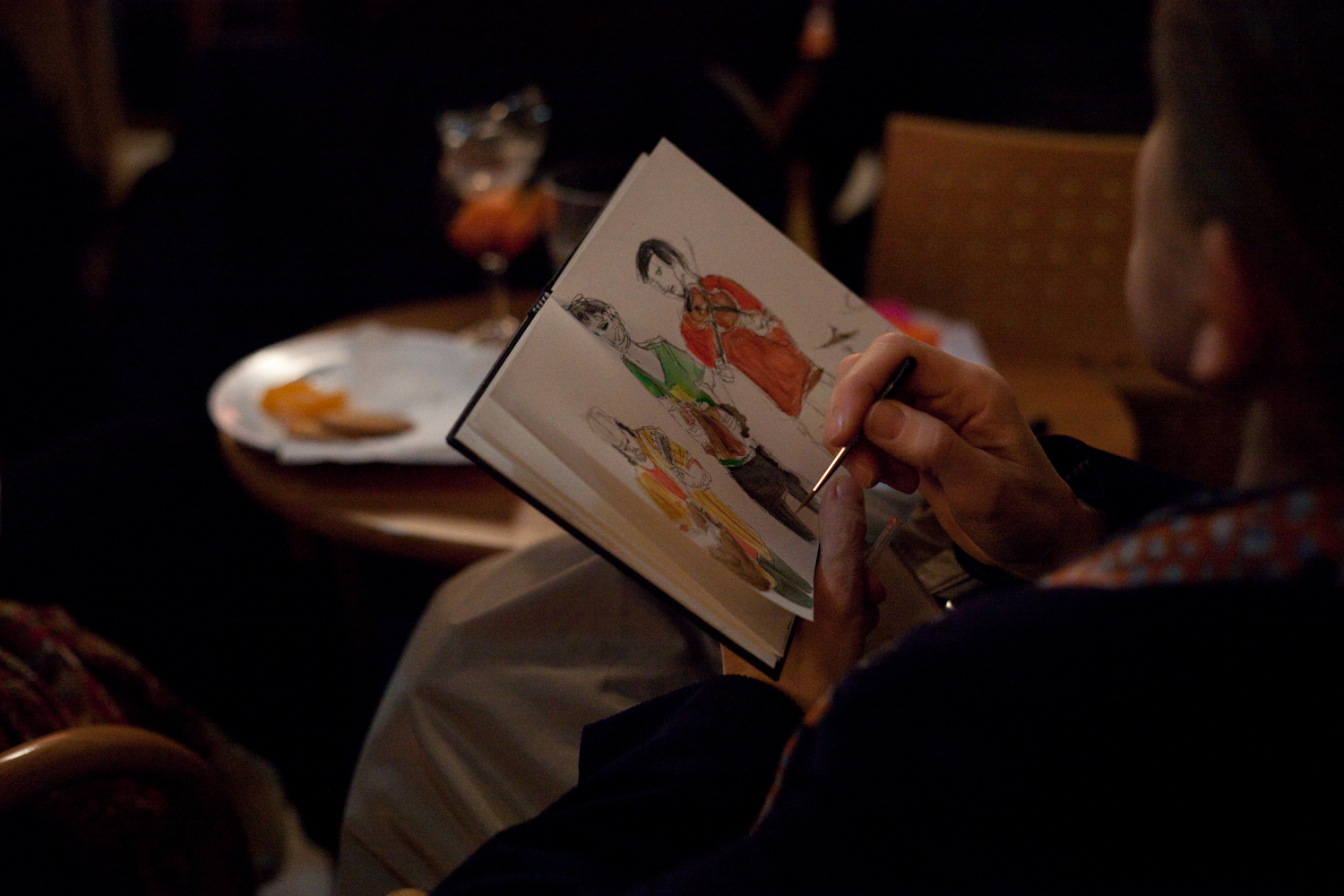 A spectator captures the band on paper.