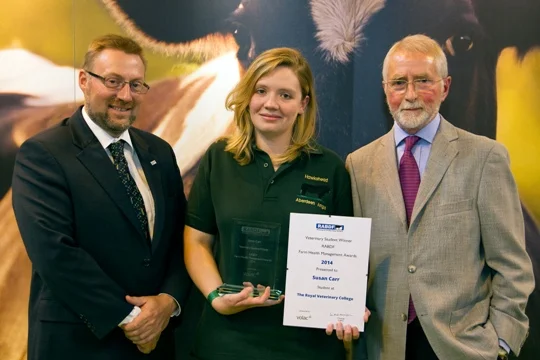 Susan Carr receives her trophy and certificate from John Reynolds, Volac and John Sumner, Chairman of the judges