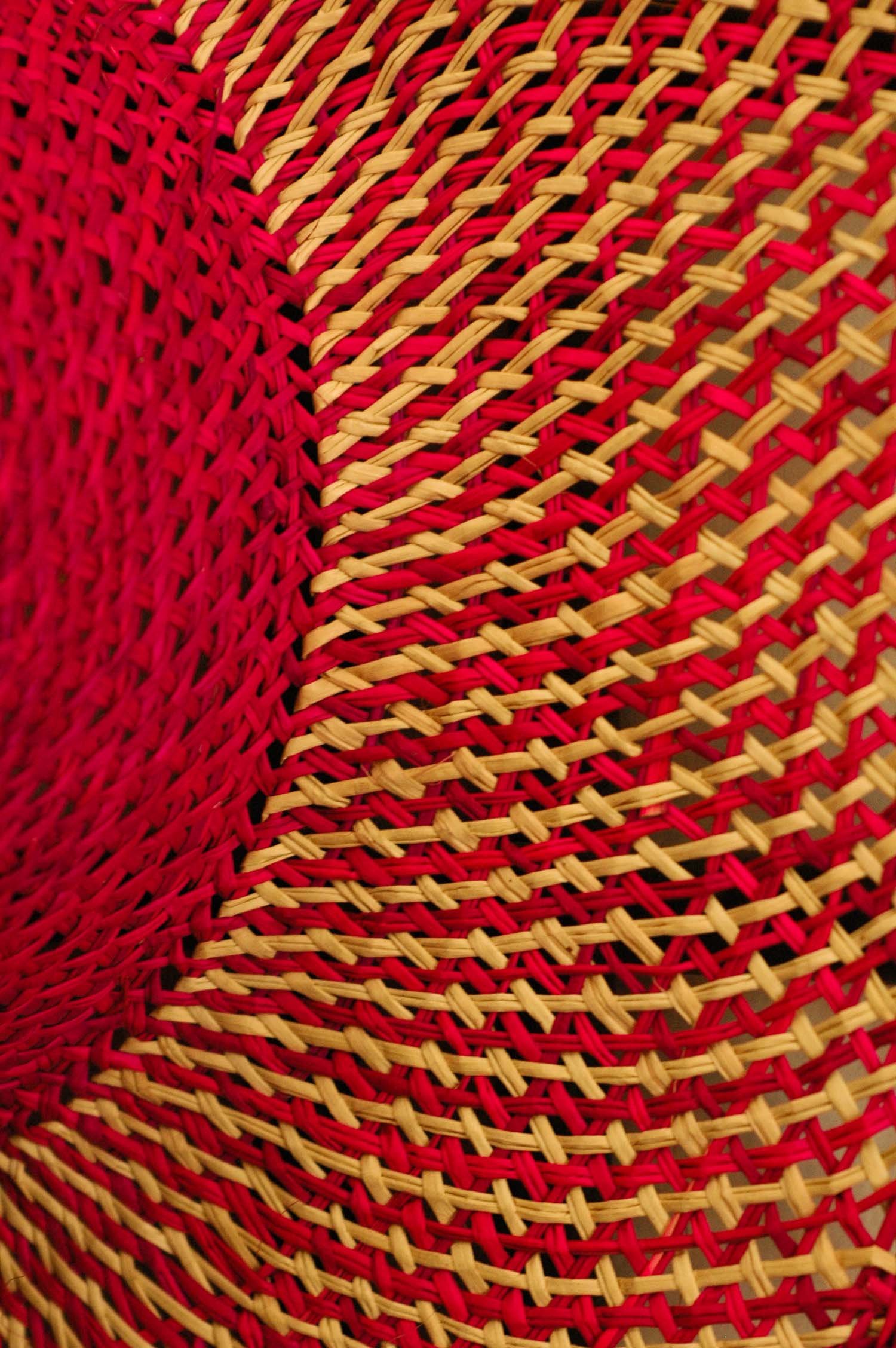 Close-up of a pink and natural straw hat