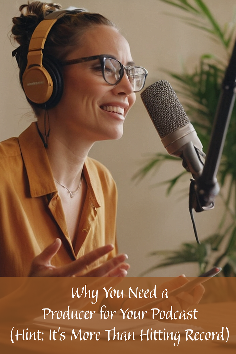 Photo of a person wearing glasses and headphones smiling as they speak into a microphone during a podcast recording