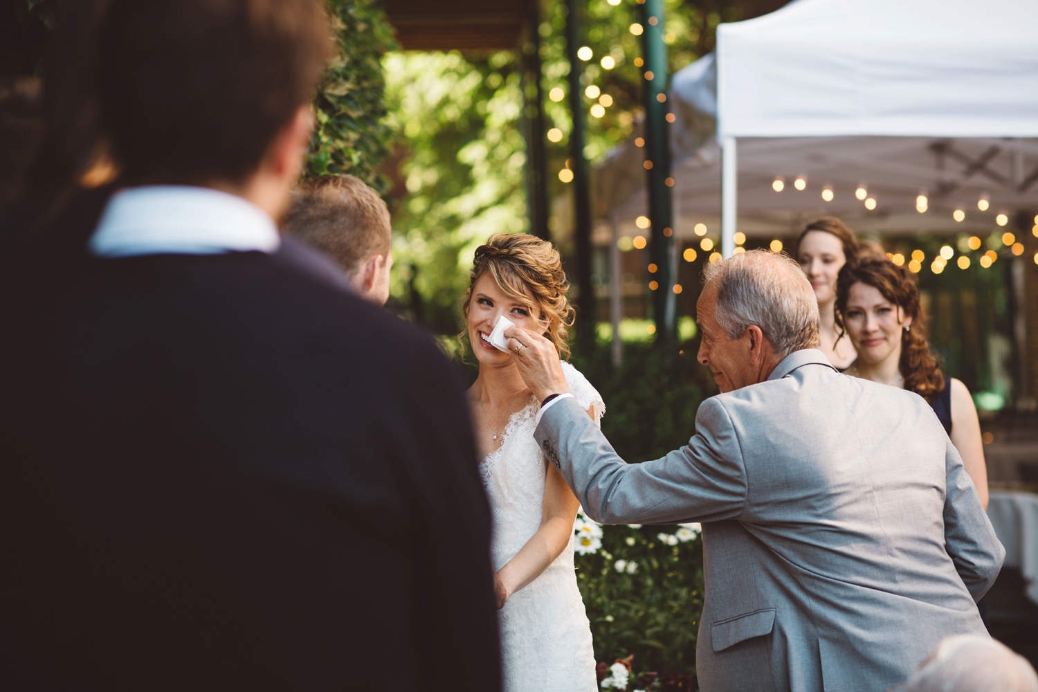 dad wiping tears for bride