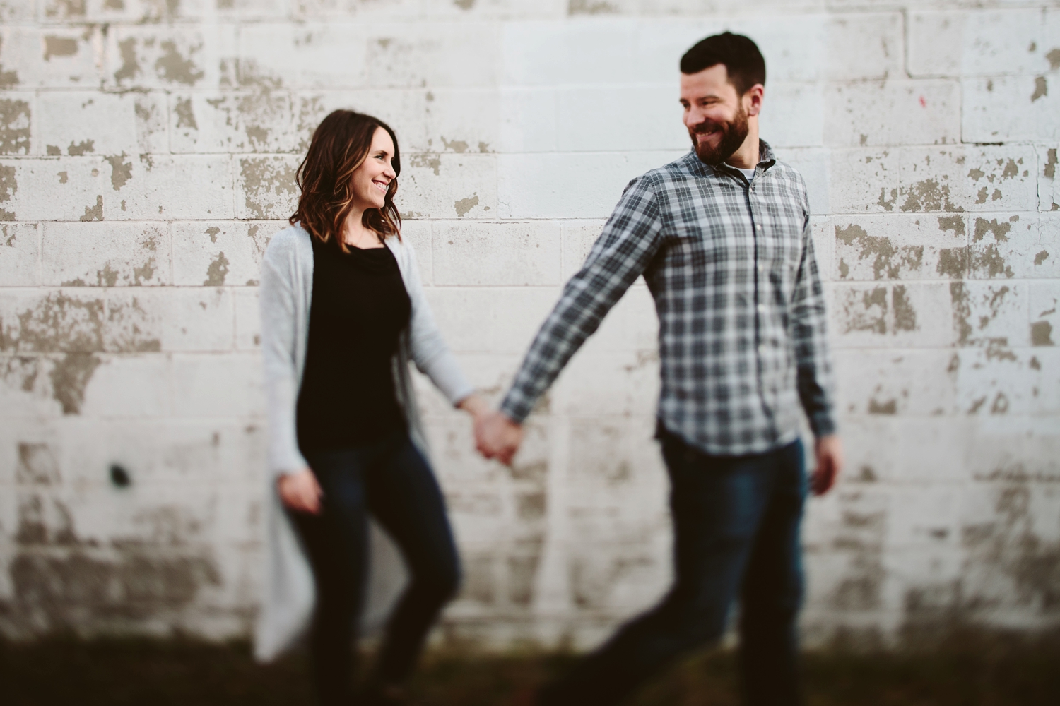 couple walking and holding hands traverse city engagement