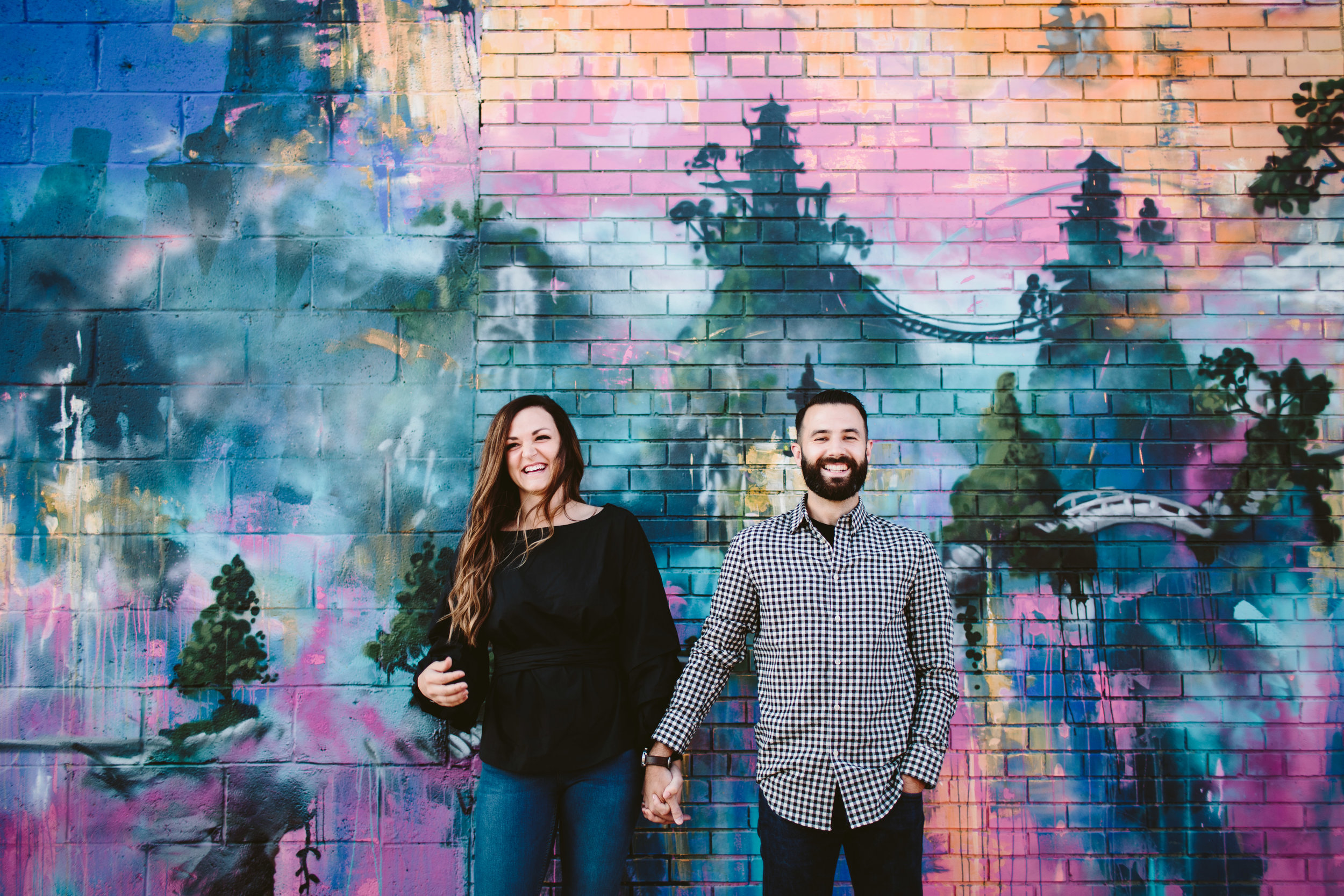 eastern market couple in front of murals