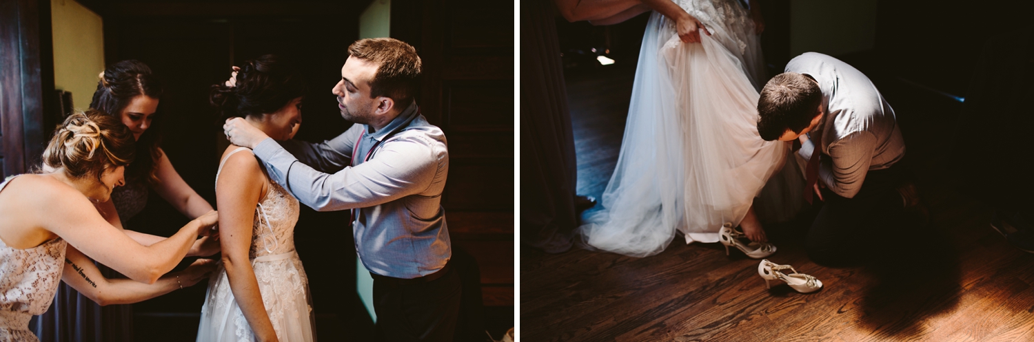 bride getting dressing in firehouse bridal suite