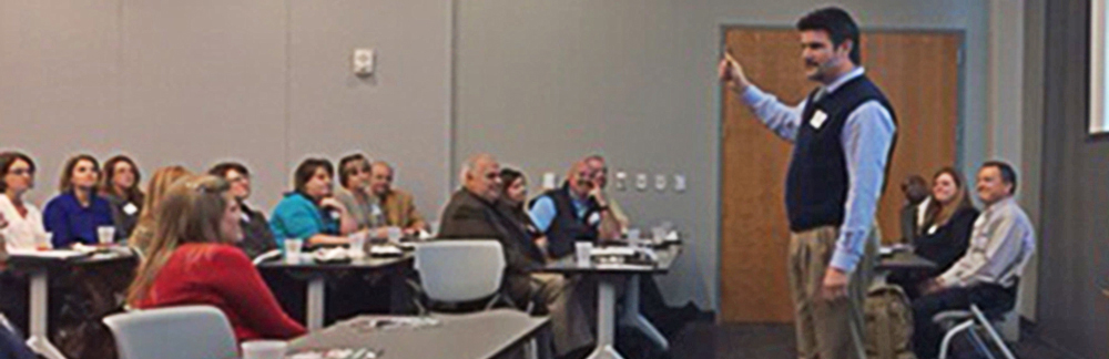 Greenville Area Supervisor David Turnipseed speaking to human resource professionals and small business managers. Jim Carino, VP of Operations at NAR, is seated to the far right.