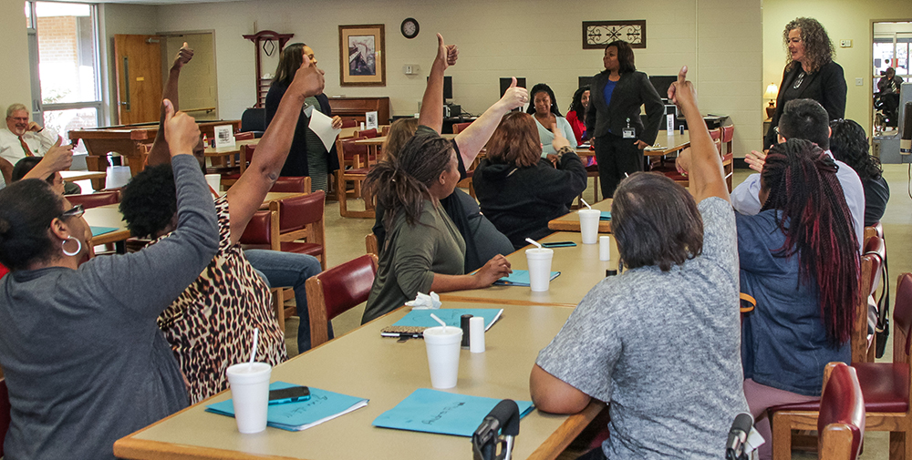 Deaf clients give their approval on the appropriateness of a model's dress during a fashion show at the Evaluation Center.