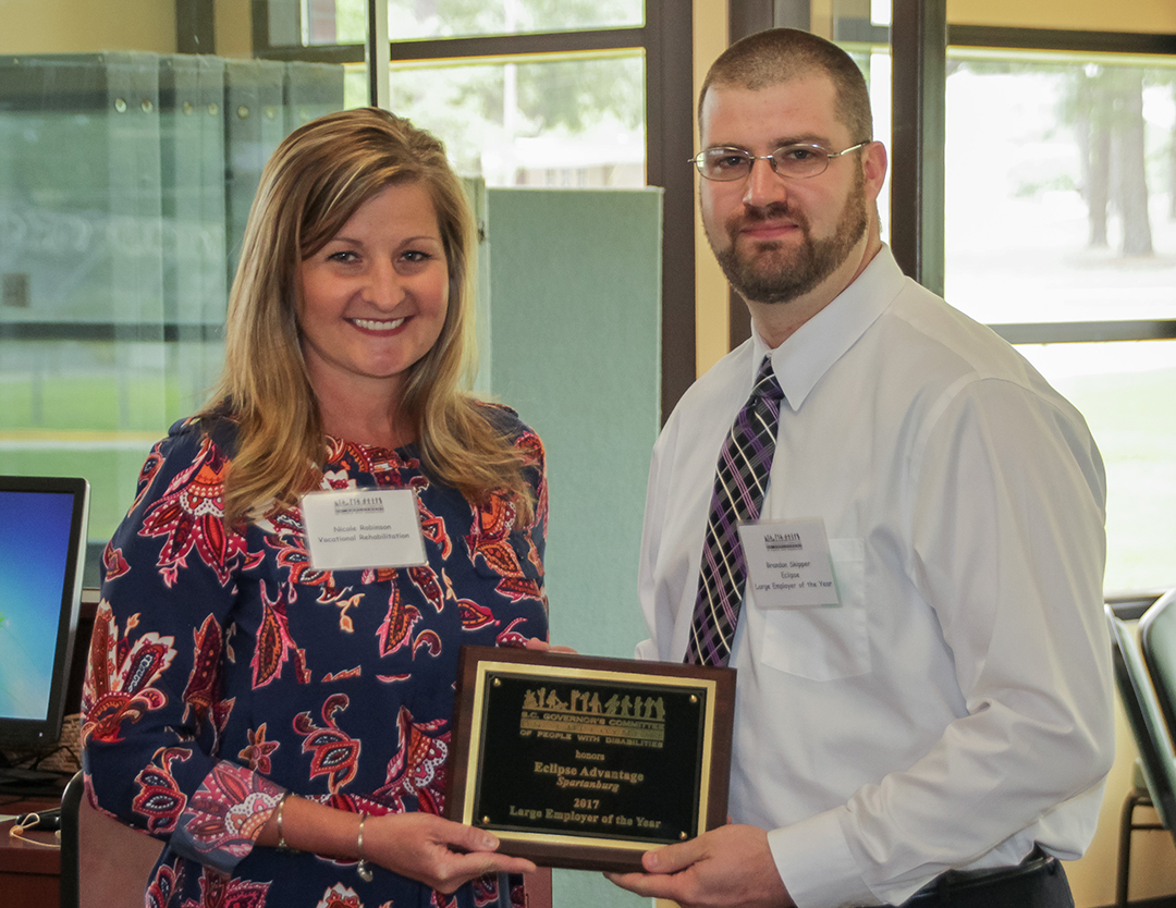 Brandon Skipper (right) of Eclipse Advantage in Spartanburg, accepts the Large Employer of the Year Award from Nikki Robinson, representing the Spartanburg Mayor’s Committee and the SC Vocational Rehabilitation Department’s Spartanburg area office.