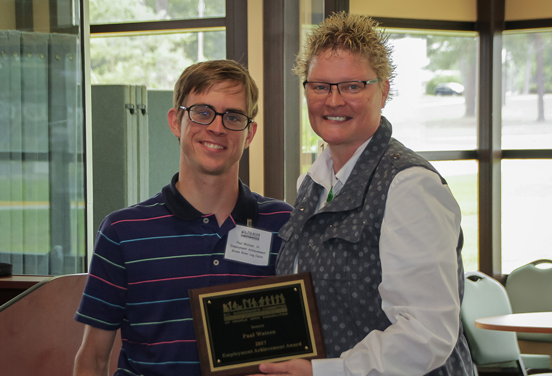 Paul Watson of Green River Log Cabins accepts the Employment Achievement Award from Amelia England, employment coach for the S.C. Vocational Rehabilitation Department, representing the Spartanburg Mayor’s Committee on Employment of People with Disabilities.