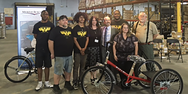 Left to right: VR clients Byron Bromell, Lonnie Cartrette, Shawn Hernandez; Tania Appel, VR Business Development Specialist; Wayne Sosin, President, Worksman Cycles; VR clients Xavier Williams, Daniel Hires, Linda Ferguson.