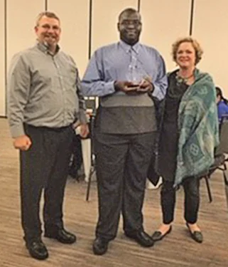 (left to right): Bill Groves, Embassy Suites General Manager; Qwavez Henderson, former VR consumer; and Kathy Rollins, Human Resources Director, Embassy Suites.