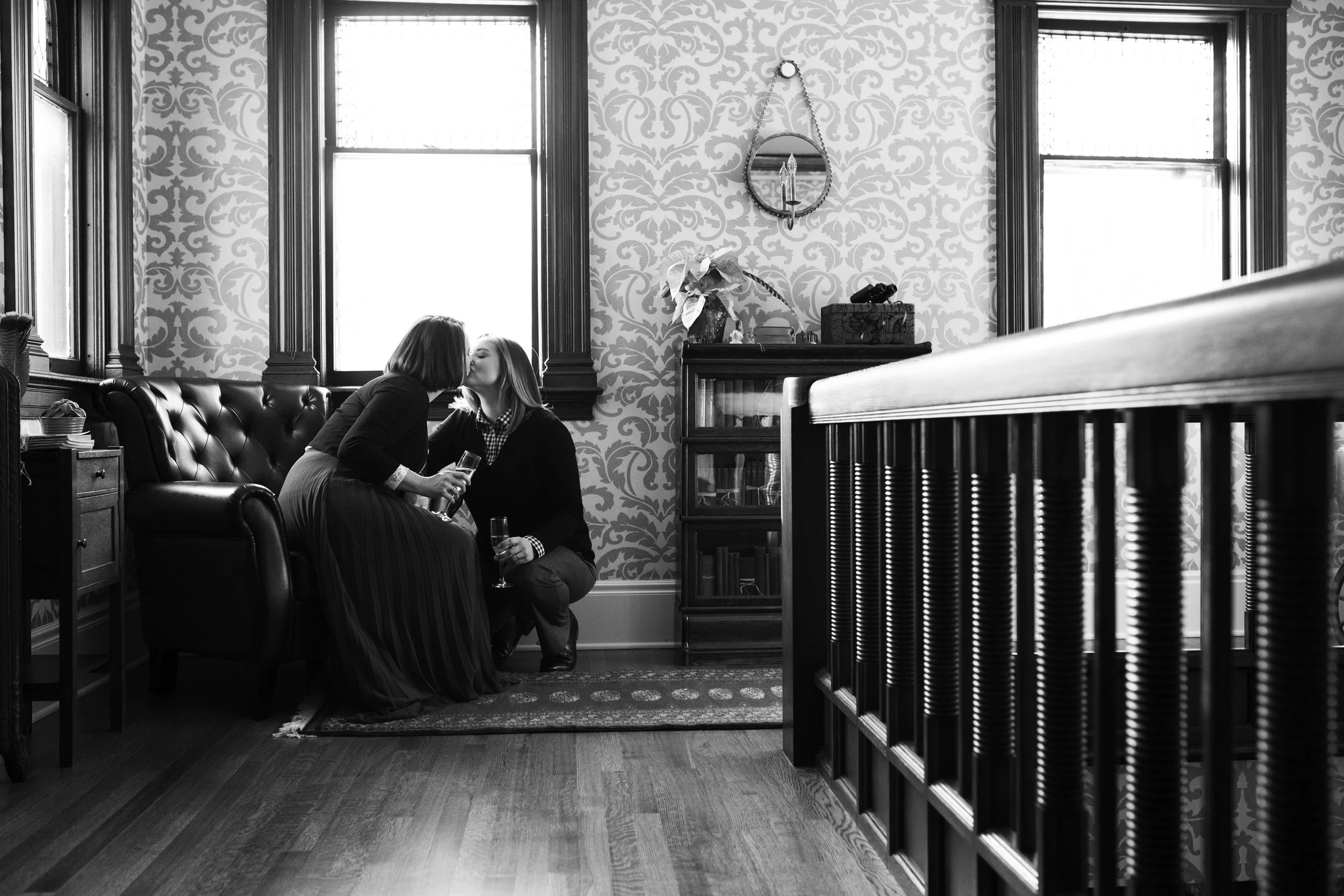 Amy and Mary take a moment with champagne before their intimate ceremony at The New Victorian Mansion . Wedding by: Melissa Hesse