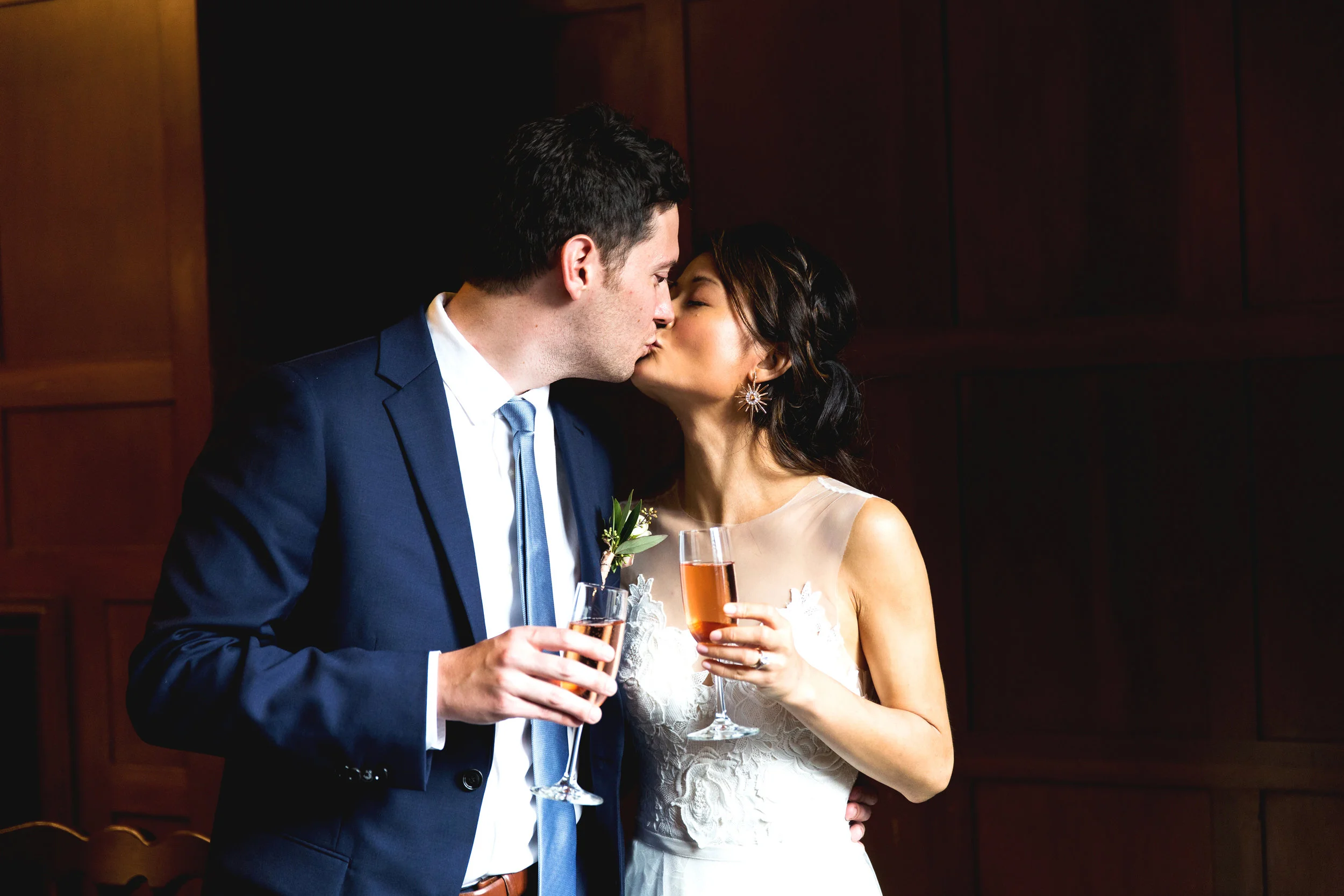 Sophie and John kiss after a toast. Wedding by: Nicole McCoy