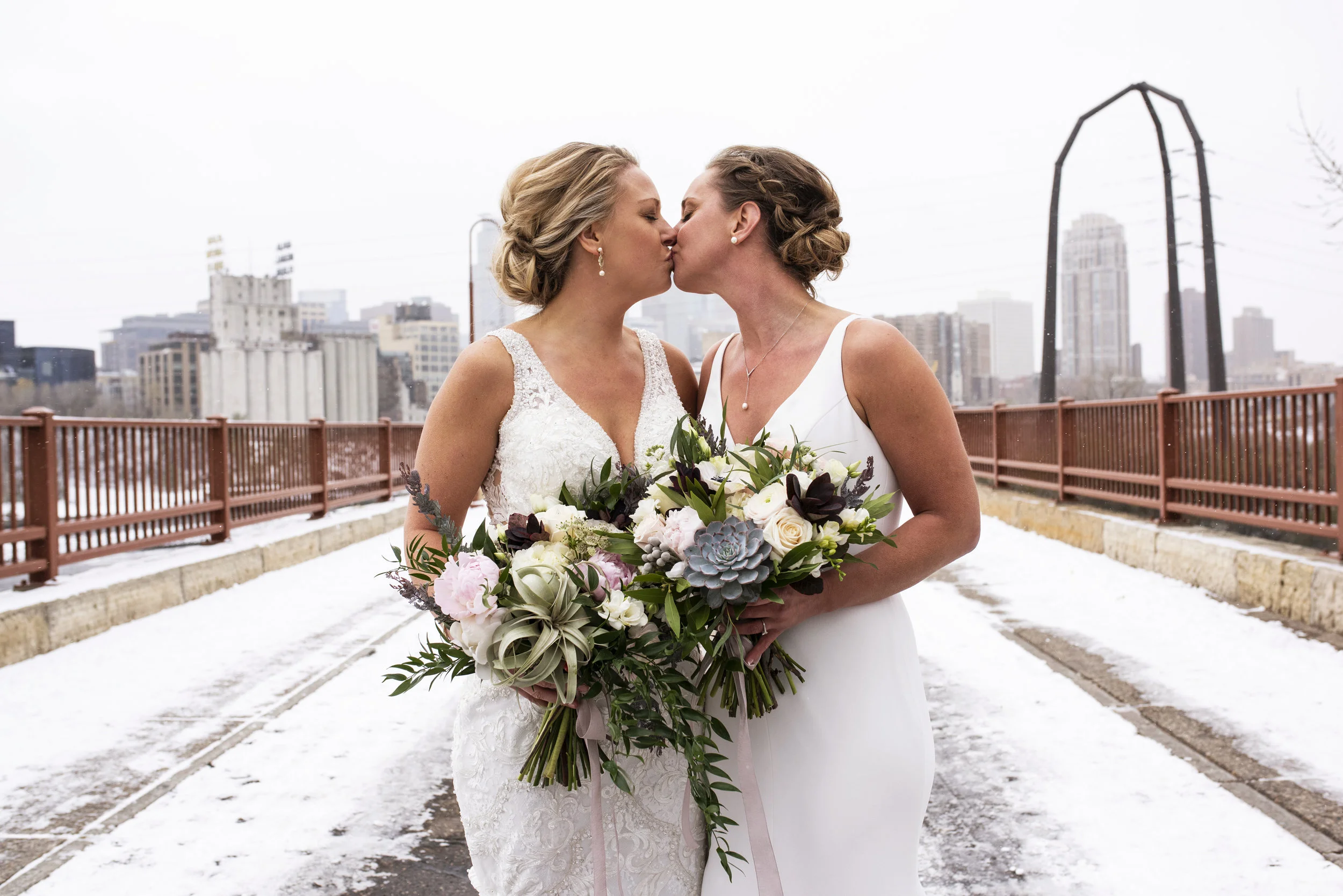 The cold and snow didn’t stop Katie and Amanda from photos on the Saint Anthony Bridge. Wedding by: Melissa Hesse