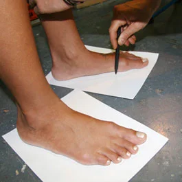 the pen should be held straight at a 90 degree angle to the paper and, should just touch the skin lightly