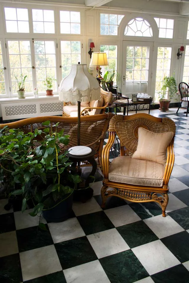 Chair in sitting area of marble floored solarium.