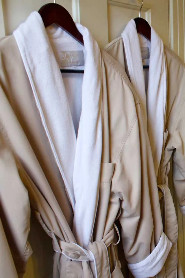 Plush bathrobes await you in the bathroom of Victorian Cabernet at this Burlington Inn.