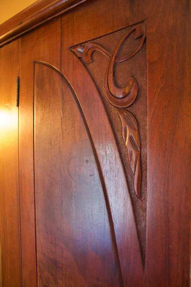 Details of antique, carved wooden armoire in Burlington’s Willard Inn.