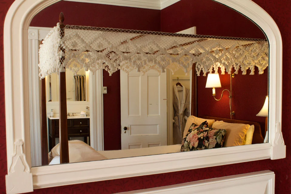 Antique wall mounted mirror over reflects luxury amenities of Champlain Lookout at Vermont’s Willard Street Inn.