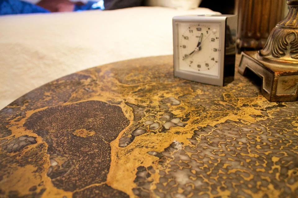 Grey Marble topped bedside tables frame the four-post king bed of Room 5 at Willard Street Inn a charming Victorian B&B.