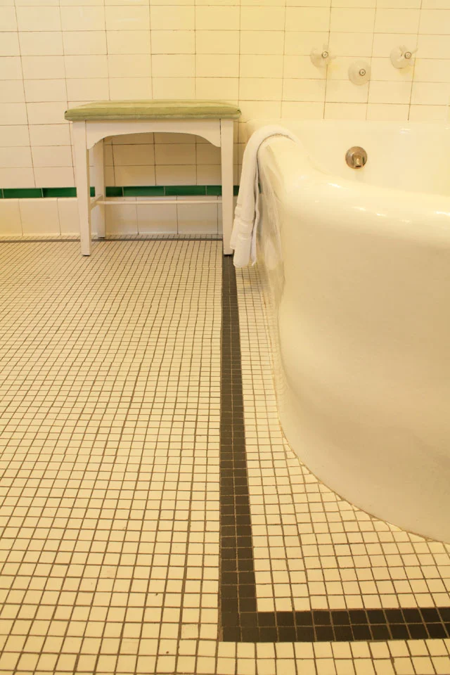 Antique tiled floor of Nantucket Room’s Bath also featuring original soaking tub and tiled shower.