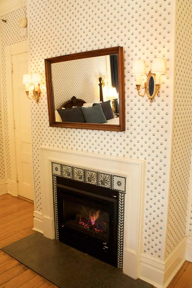 Gas fireplace with mosiac tile at Willard Street Inn a burlington, vermont bed and breakfast.