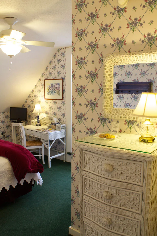 Wicker chest of drawers and mirror in the Tower Room of the Willard Street Inn.