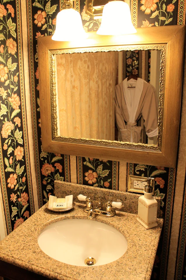 Granite vanity top with antique mirror in private bath of Rm 14.