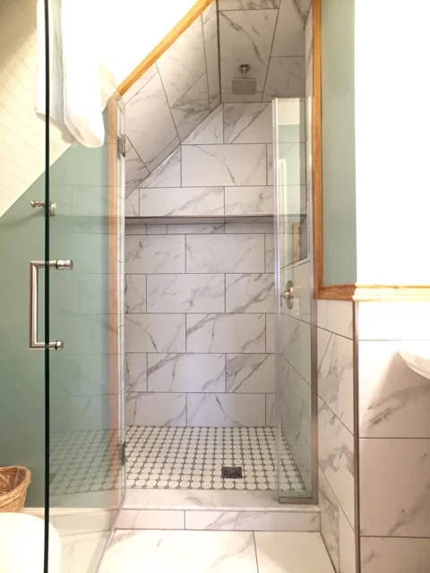 Tiled shower with bench makes wonderful use of space in the bathroom of Room 11.