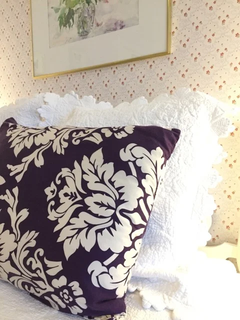 Plush linens and pillows appoint the queen bed of Room 9.
