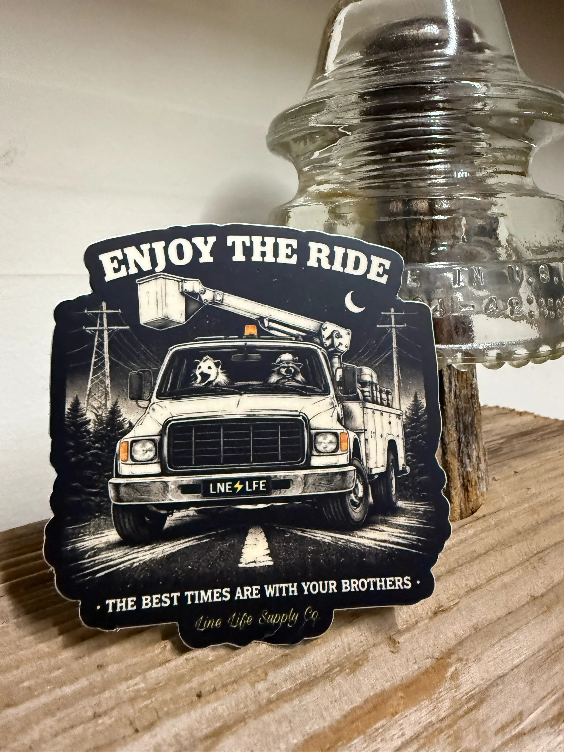Vintage lineman bucket truck decal with “Enjoy The Ride” text and utility power lines designed for hard hats, trucks, and toolboxes.