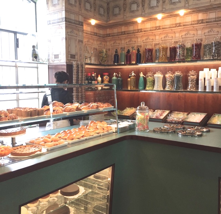Jars of candy and italian pastries in the case.