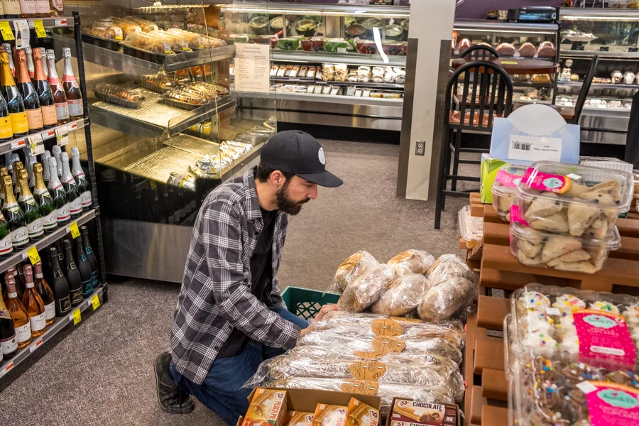 Tony stocking the shelves at Silver Street Market in downtown ABQ.