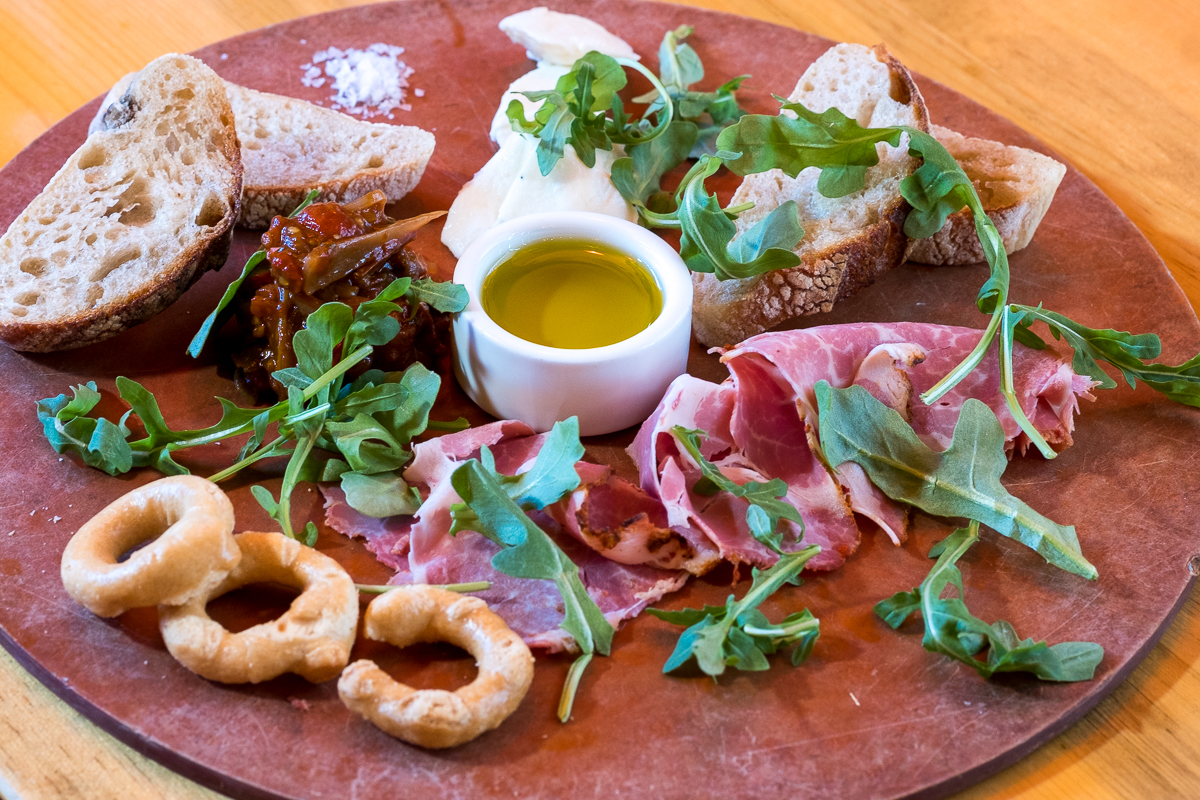 M’tucci’s Italian Charcuterie Board C: Capicola, Sweet Onion & Tomato Agrodolce, Smoked House Mozzarella, House Made Bread and Taralli.