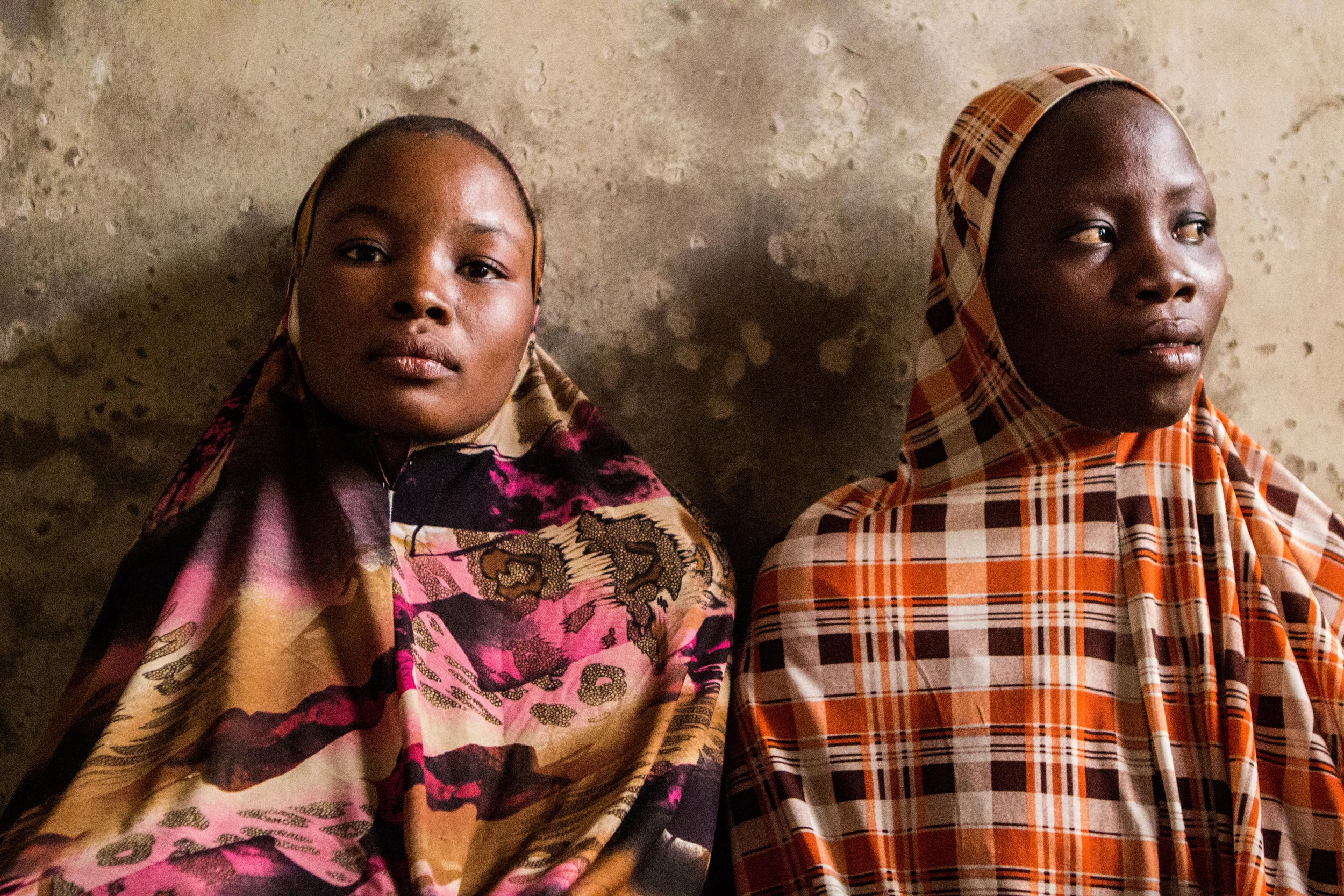 Yola, Nigeria. March 7 2015. Hadiza Ibrahim, 22 and Rukayya, 20 stayed in their hometown after Boko Haram militants attacked and their husband fled for his life. “They both wanted to marry me,” Hadiza said. “They said that, since he left, I was part of their property.” 