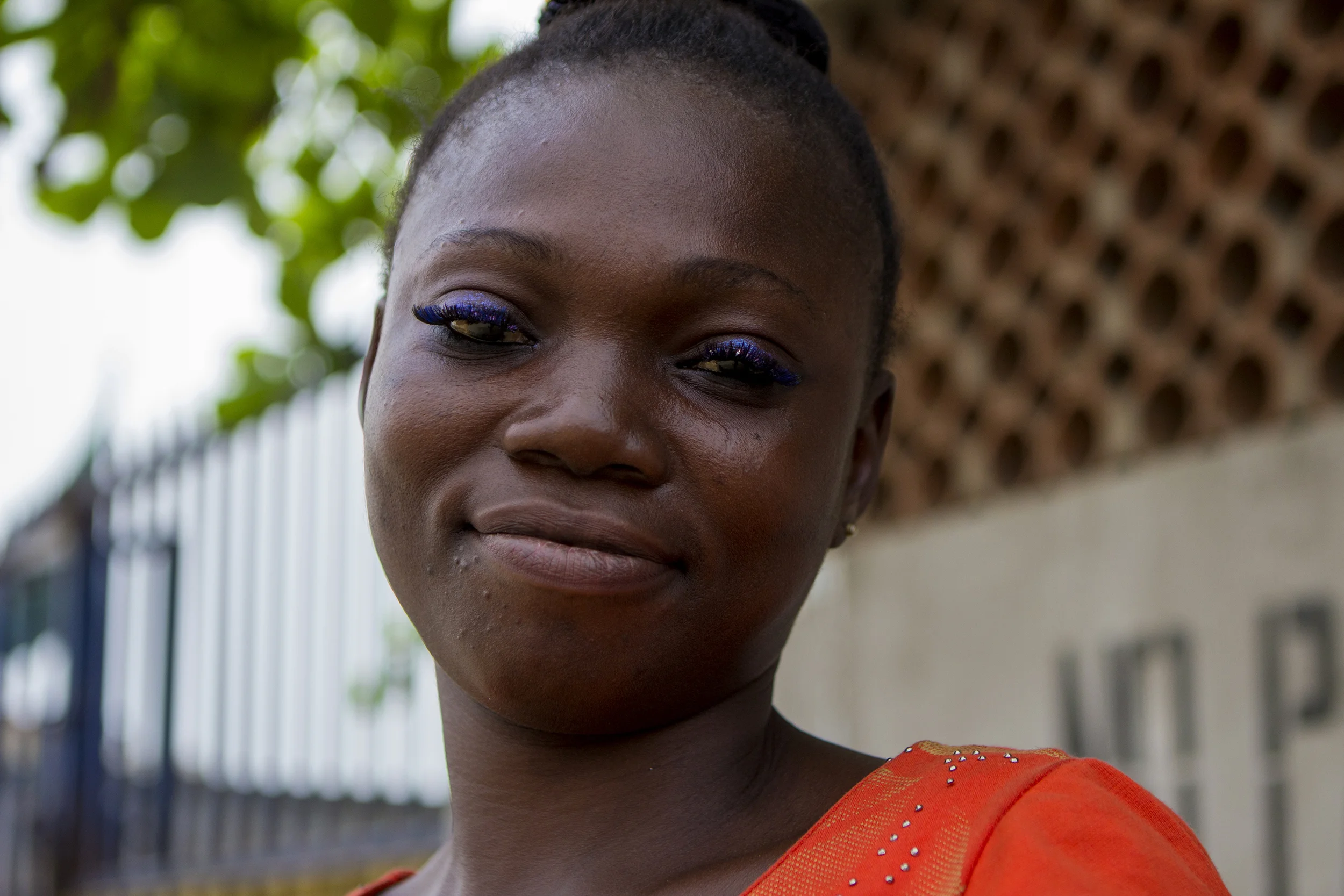 A woman poses for a photo while waiting for her bus to work in Lagos, Nigeria on Feb. 25, 2015. 